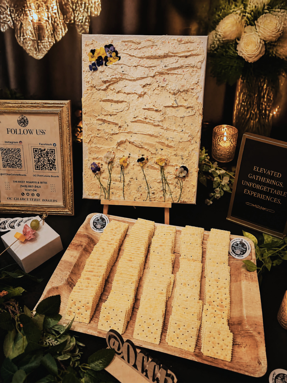 Close-up of edible cheese canvas art with floral cheese design and crackers, Orange County