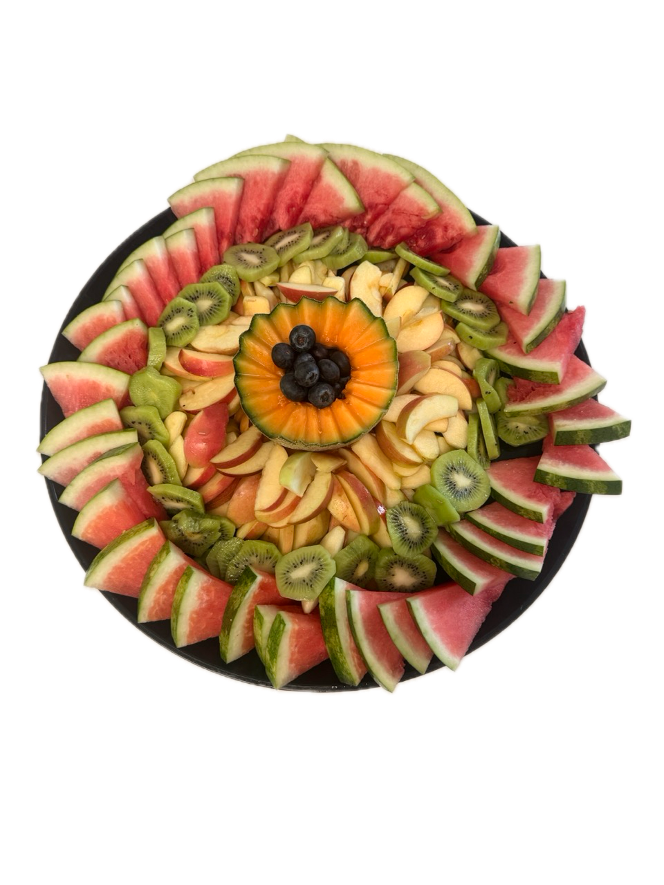 Circular fruit platter in concentric rings on black plate with sliced watermelon for Newport Beach catering