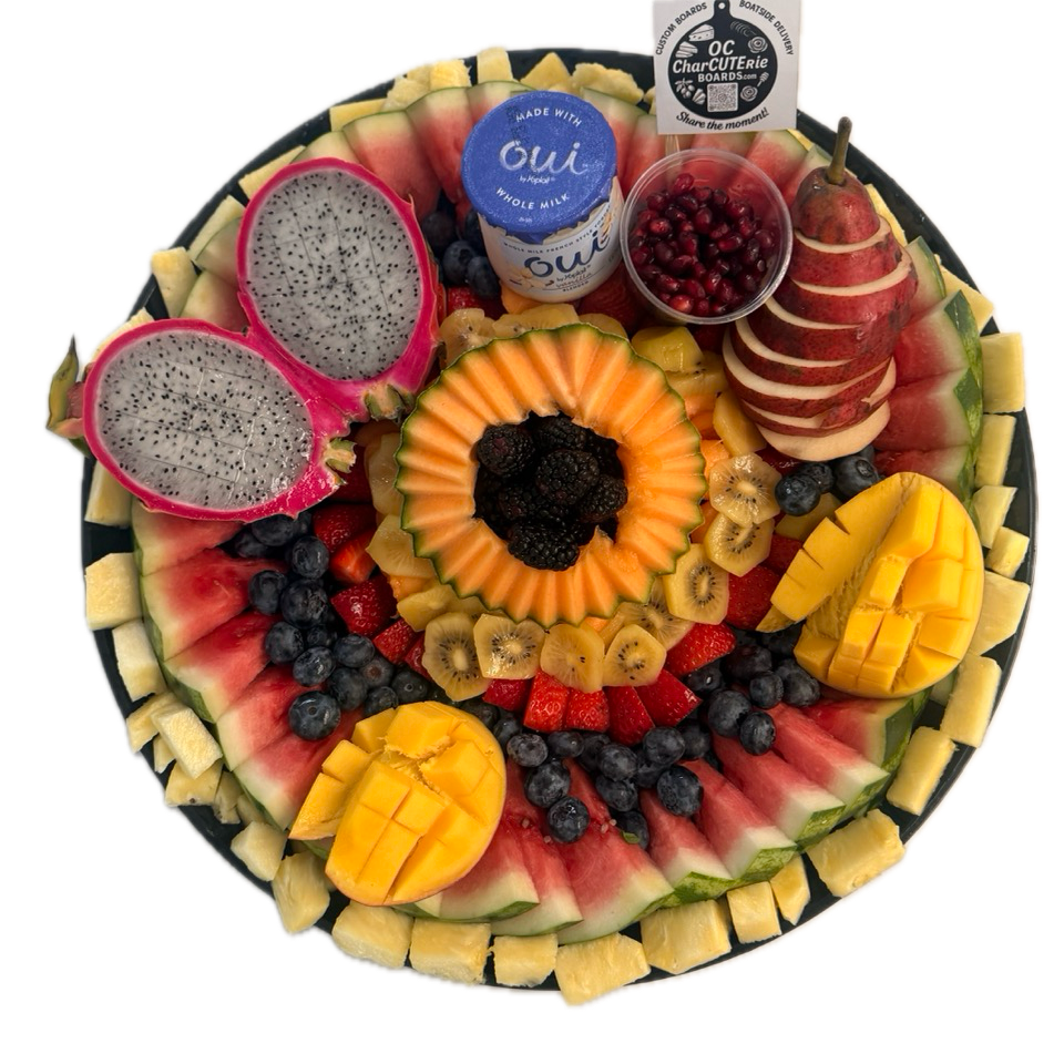 Large colorful fruit platter on black plate with sliced watermelon and dragon fruit for Orange County catering