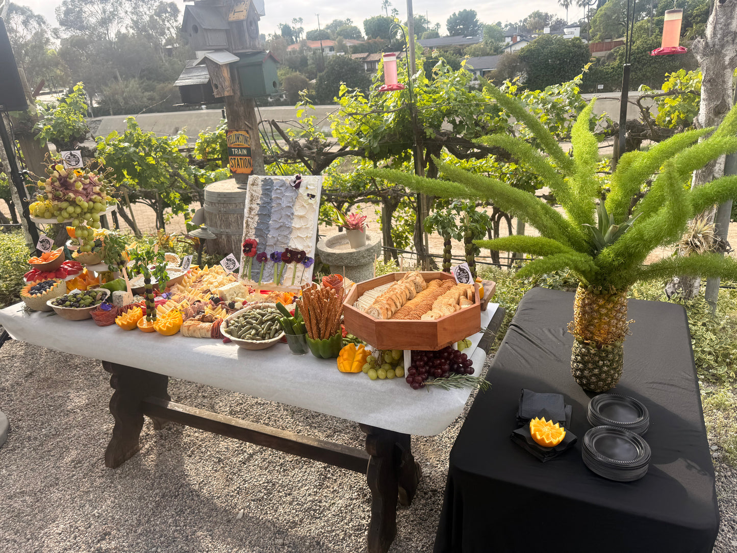 Elevated grazing table featuring edible cheese canvas art centerpiece for corporate events, Orange County