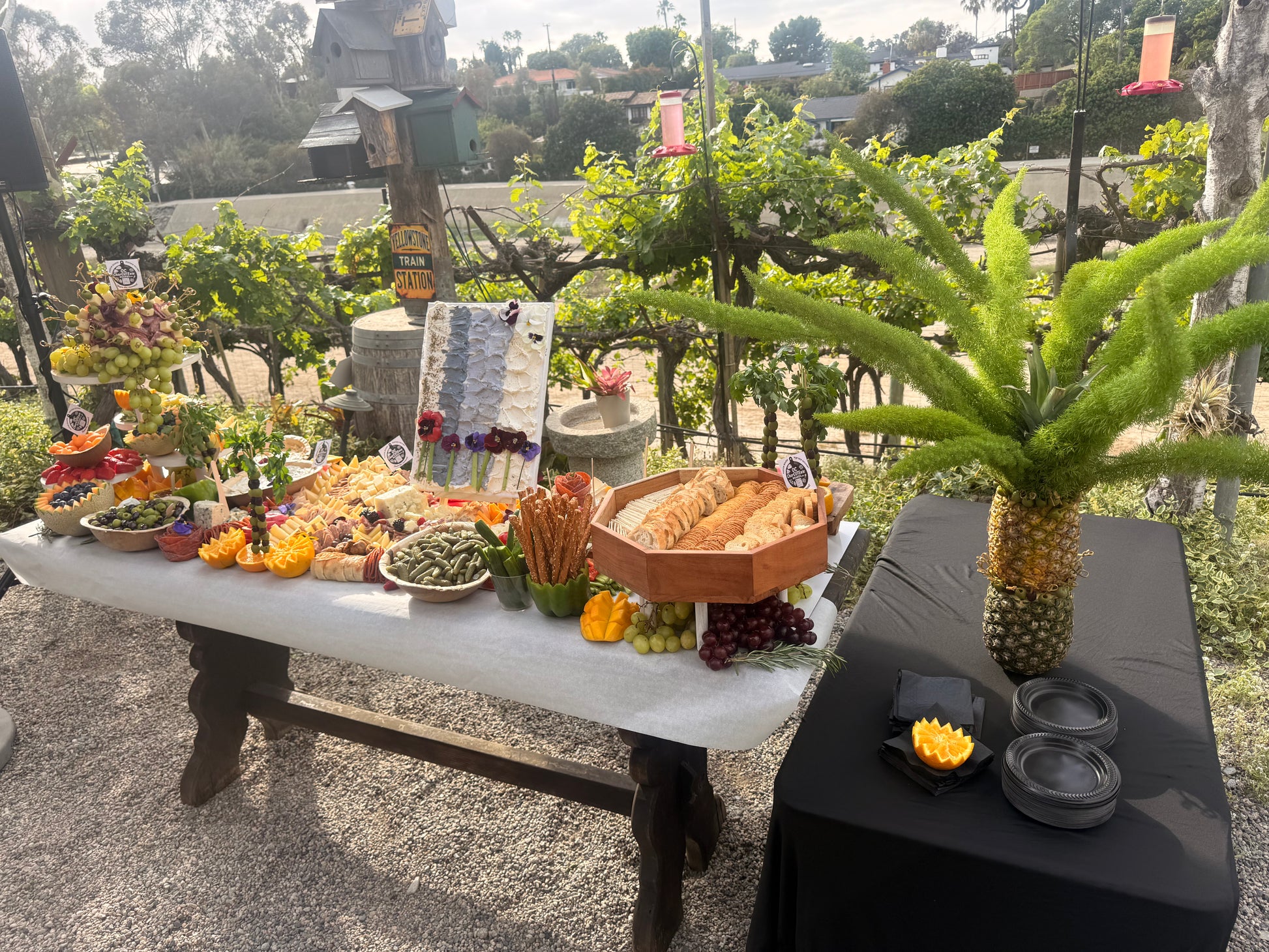 Elevated grazing table featuring edible cheese canvas art centerpiece for corporate events, Orange County
