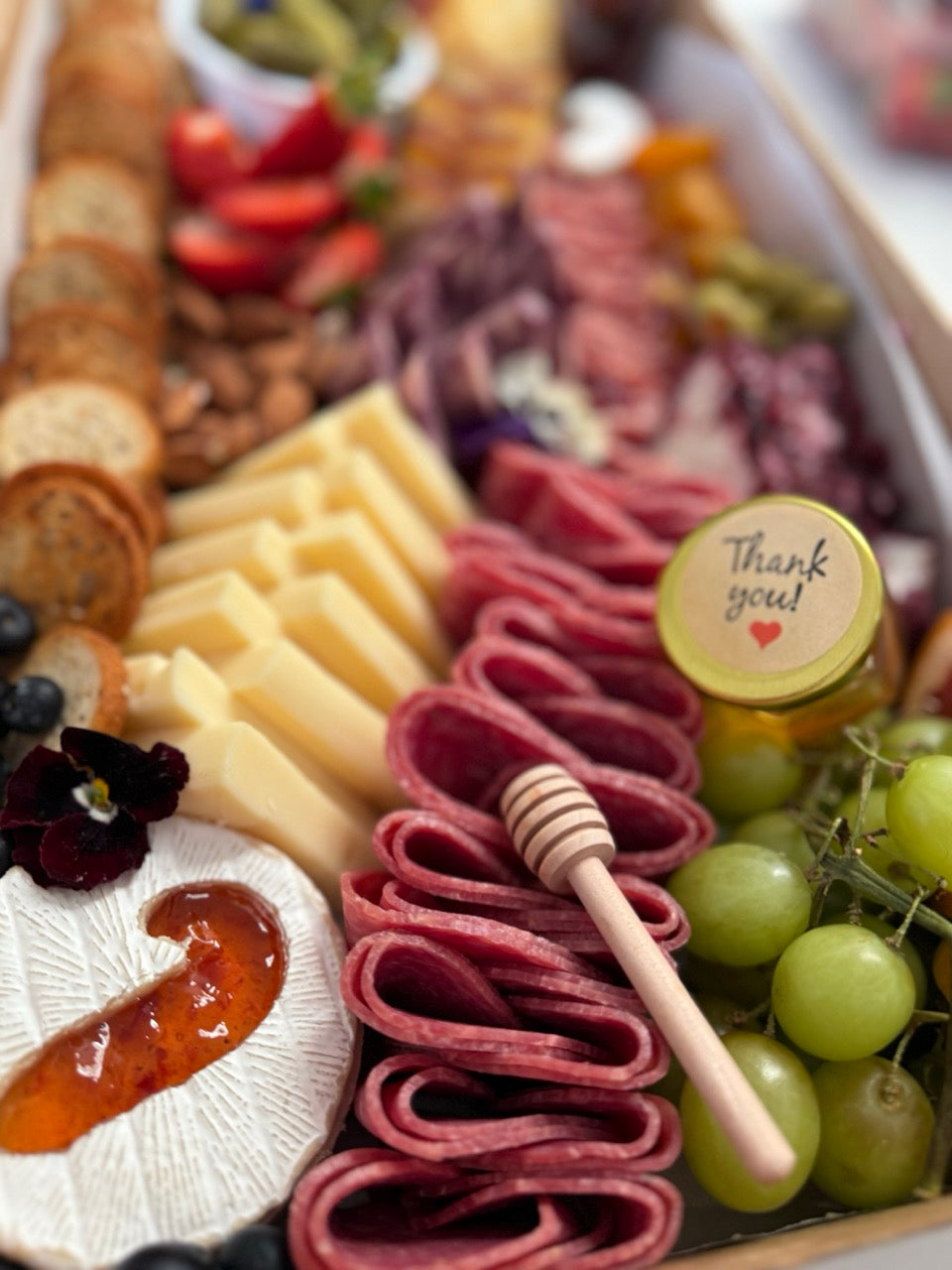 Holiday charcuterie box with salami rosettes, cheeses, grapes and crackers for Newport Beach holiday party catering