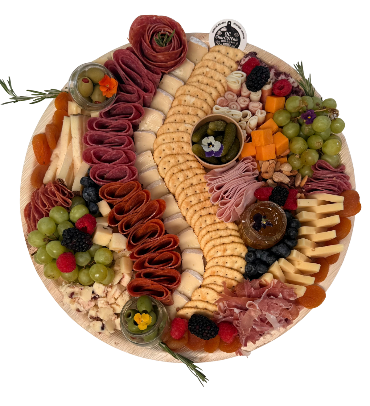 Medium charcuterie board with curved crackers, folded cured meats, assorted cheeses, grapes, berries, and rosemary.